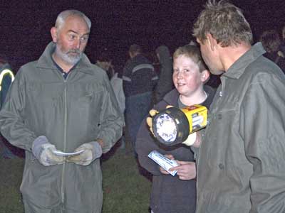 Phil Elliott (l) & Eddie Hatcher (r), our two fireworks artistes, present Hugo Mills (winner of the guy competiton) with his prize.