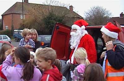 Santa Claus dropped in to give presents to the children.